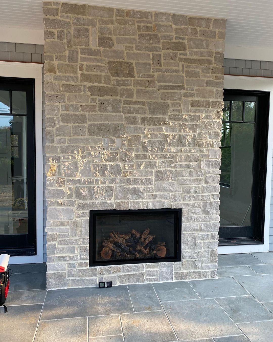 Outdoor fireplace chimney with custom masonry installed and maintained by Alpine Fireplaces
