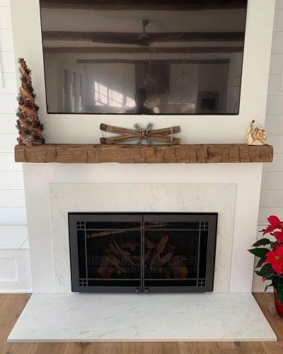 Holiday decor on mantel over fireplace installation in residential home.