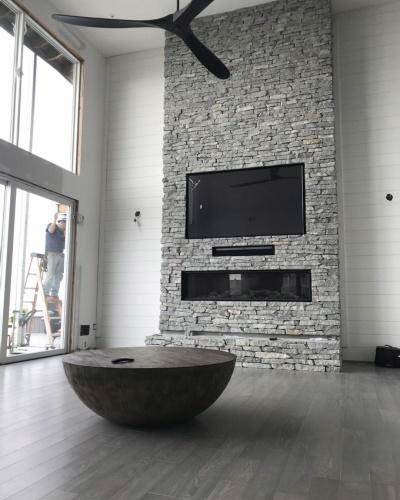 Tall ceilings and masonry stone work for indoor fireplace installation from Alpine Fireplaces.