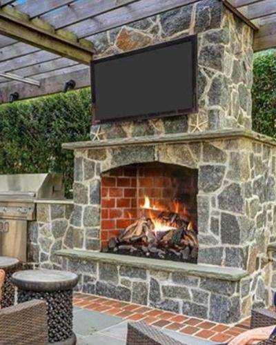 Outdoor fireplace installation with stone work from Alpine Fireplaces