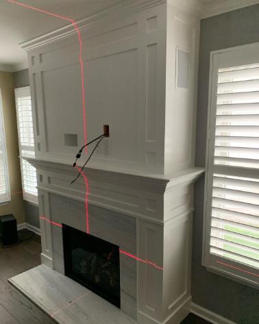 Laser level with precision fireplace installation contractors for residential home Alpine Fireplaces