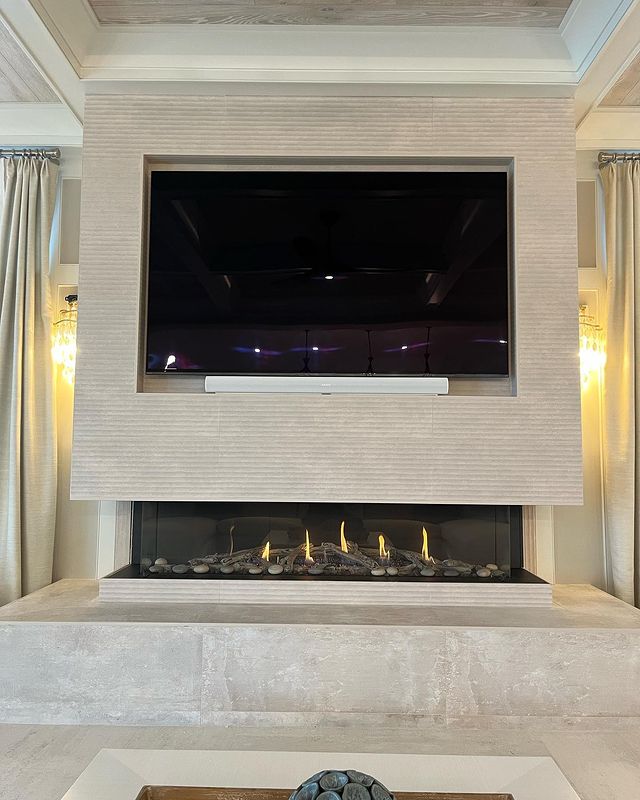 TV Wall Mounted over white masonry and brick installation of fireplace from Alpine Fireplaces.